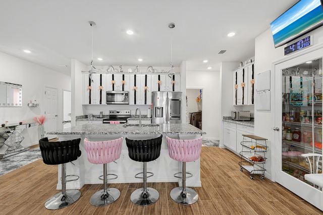 Kitchen with granite island, breakfast bar and stainless appliances